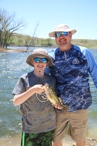 Adult with child holding a fish