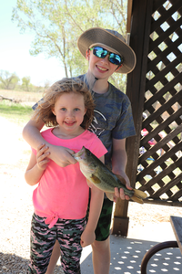 Two kids holding a fish